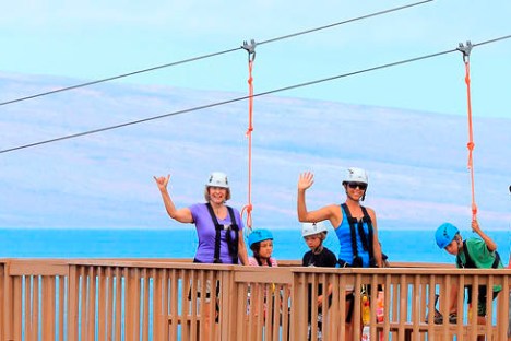 a man standing on top of a wooden fence
